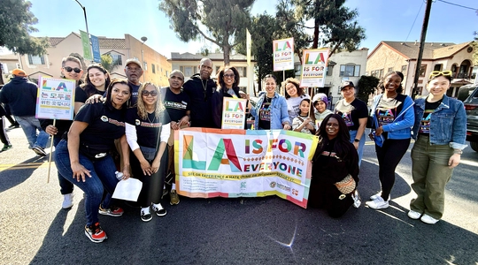 LA Civil Rights staff and Black Worker Center staff hold up LA is For All signage.