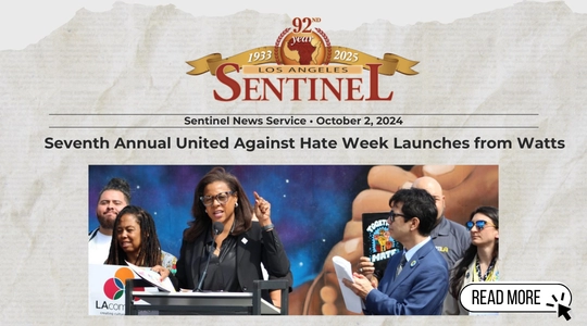 Image shows Capri Maddox speaking at a podium during the launch of United Against Hate Week in Watts. She is joined by city and community leaders, with a colorful mural in the background. The event is featured in the Los Angeles Sentinel, dated October 2, 2024.