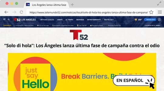Screenshot of the Telemundo 52 Los Angeles website. The headline reads "Solo di hola": Los Ángeles lanza última fase de campaña contra el odio" ("Just say hello": Los Angeles launches last phase of anti-hate campaign). Below the headline, there's a graphic with the words "just say Hello" on the left and "Break Barriers. B" on the right. There's also a button labeled "EN ESPAÑOL" (in Spanish) in the bottom right corner.