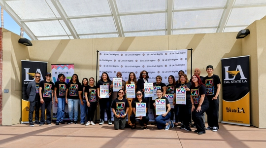 Group of LA Staff and volunteers holding I Belong posters.