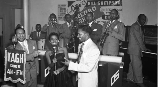 	 Bill Sampson at microphone with band playing at Jack Basket Room fro KAGH. Jack’s Basket Room, also called Jack’s Chicken Basket and Bird in the Basket was an after hours jazz club and restaurant in the heart of South Central Los Angeles., 1949
