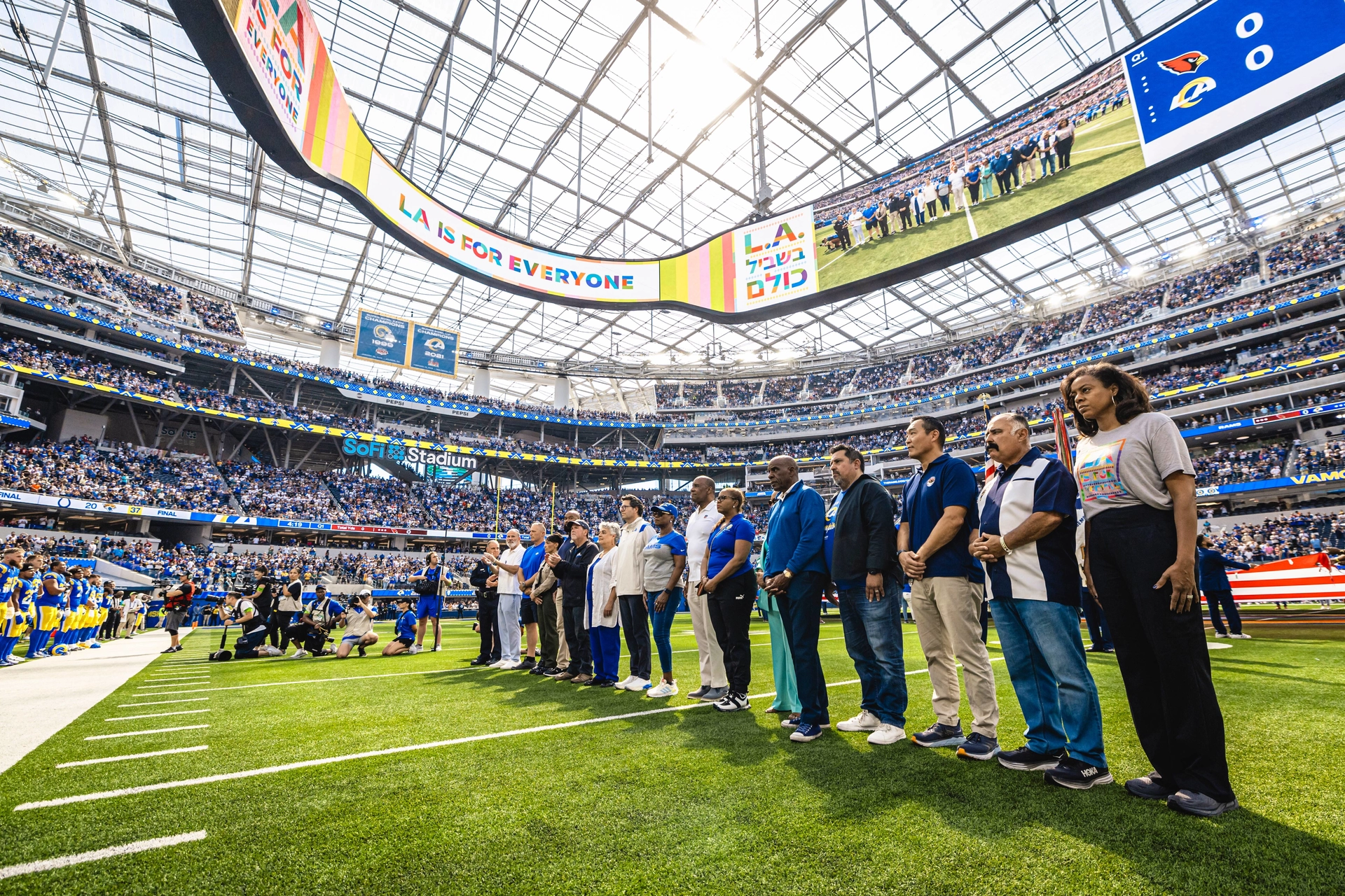Photo of City leaders standing in solidarity against hate on the field at Sofi Stadium
