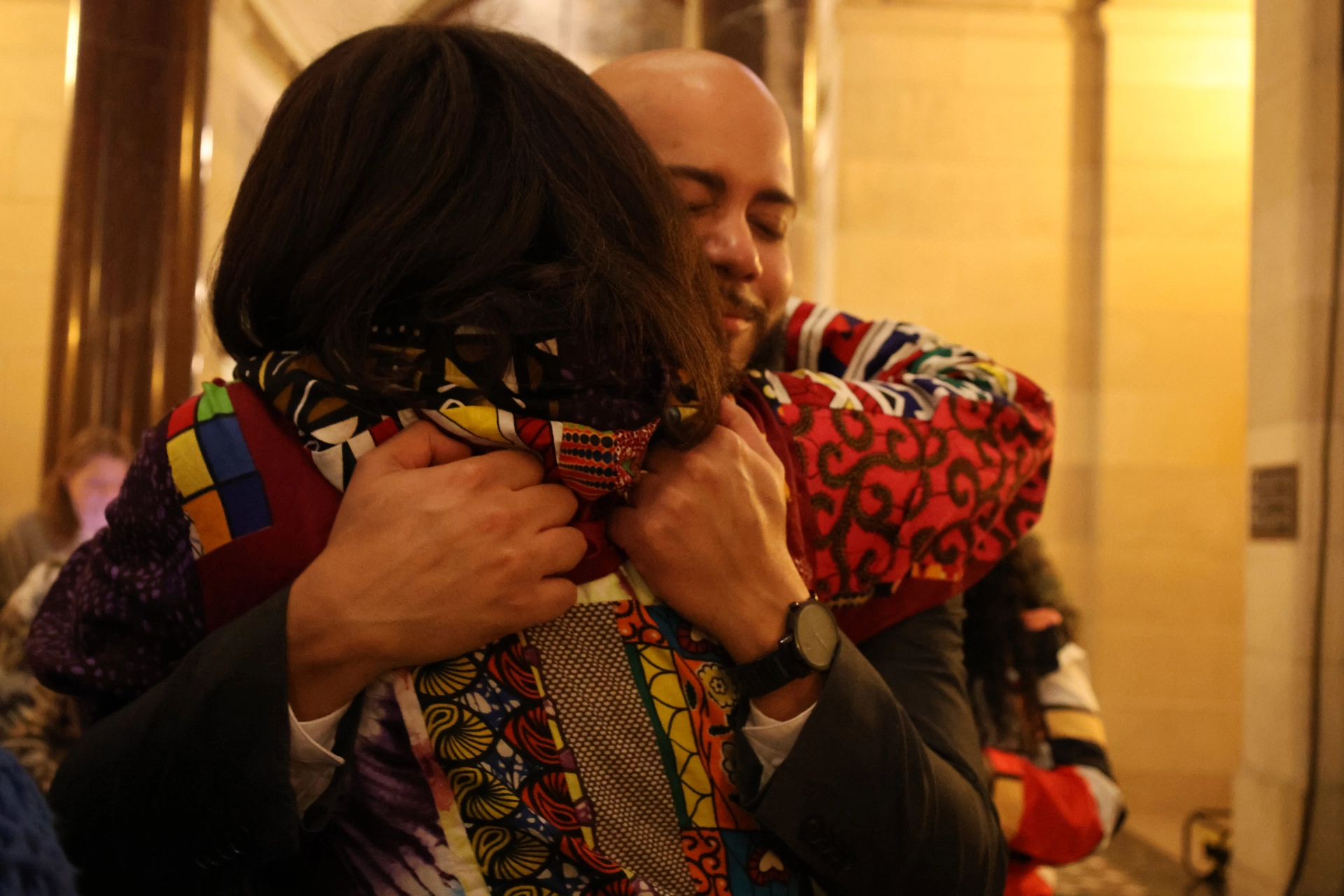 Isaac Bryan and E.D. Capri Maddox embrace.