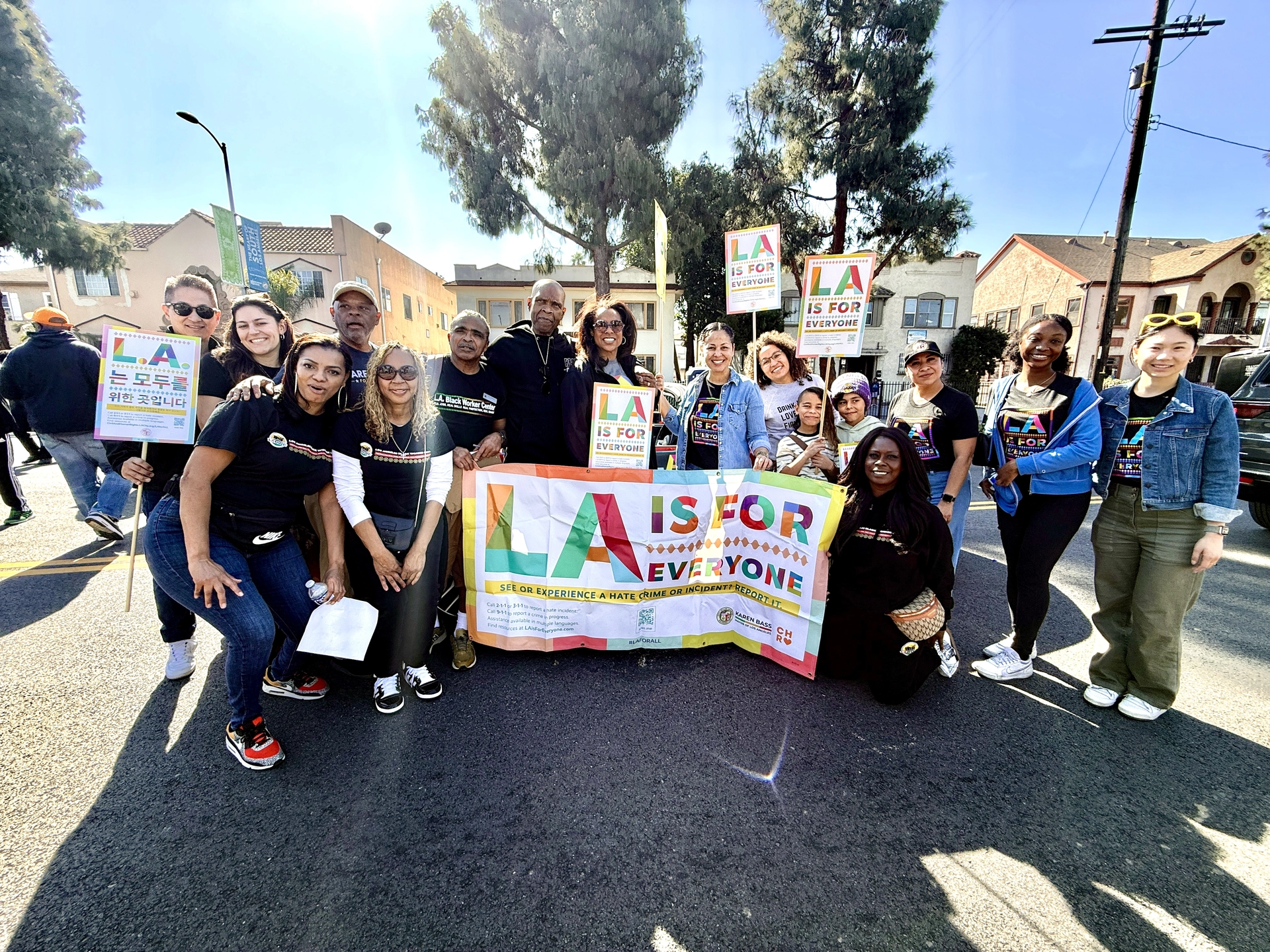 LA Civil Rights staff pose with LA For All and Just Say Hello signage.