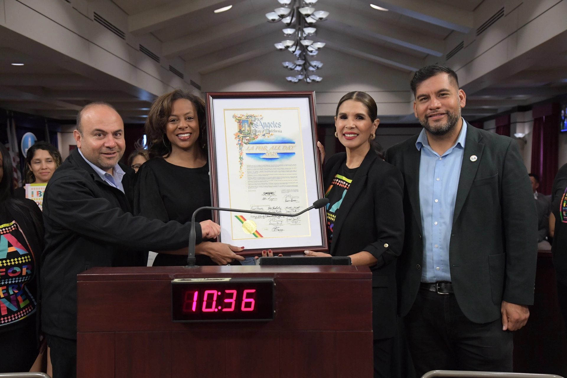 Councilmembers Nazarian and Soto-Martinez stand with Executive Director Maddox and General Manager Marguez at Van Nuys City Hall Council Chambers podium posing with 2025 LA For All Resolution officially declaring the 4th Annual LA For All Day in LA