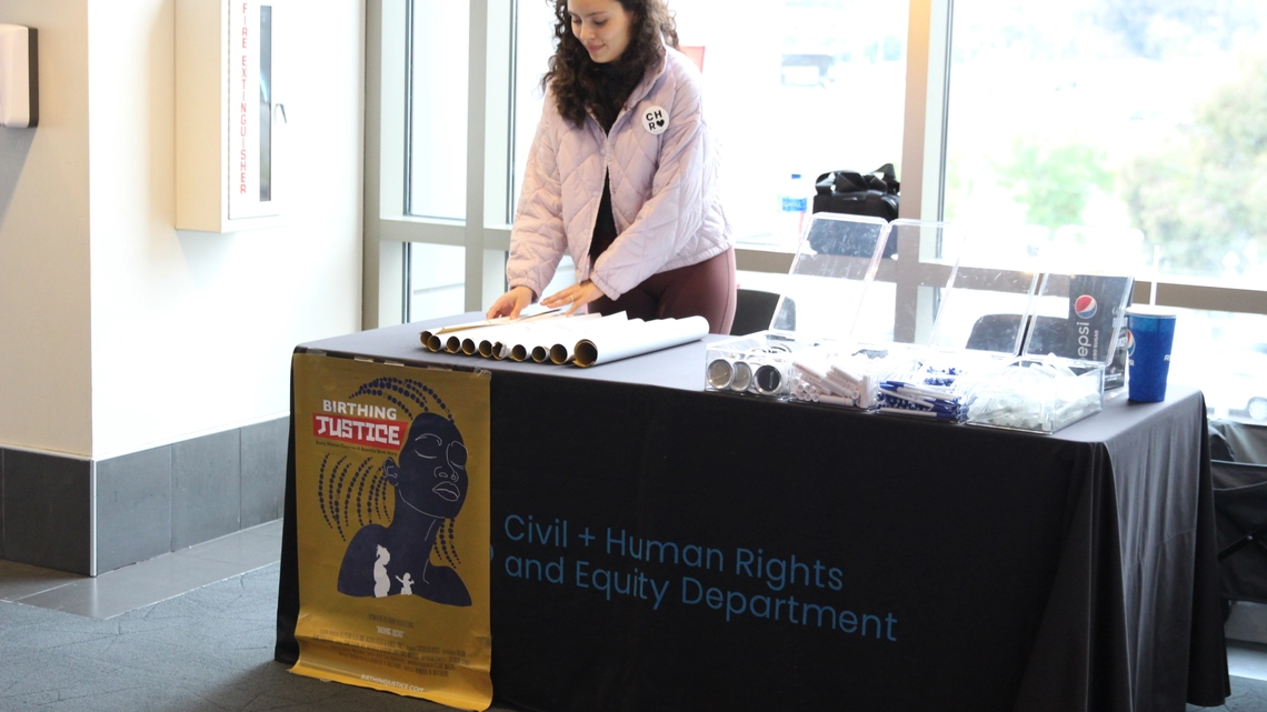 LA Civil Rights volunteer staffs a table for Birthing Justice on April 12, 2023