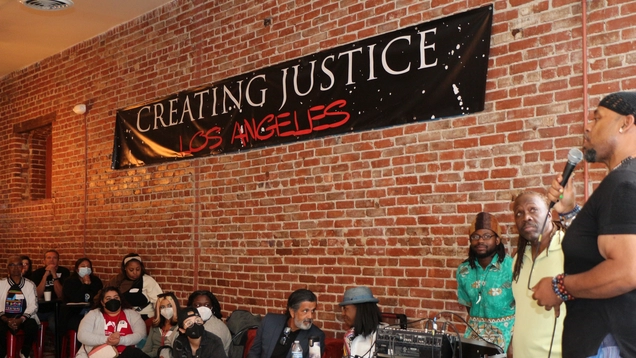Kayo from Creating Justice LA speaking to people on stage