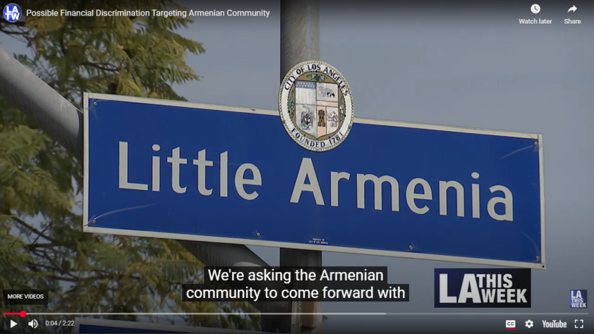Image of Little Armenia street sign with closed caption words on YouTube video