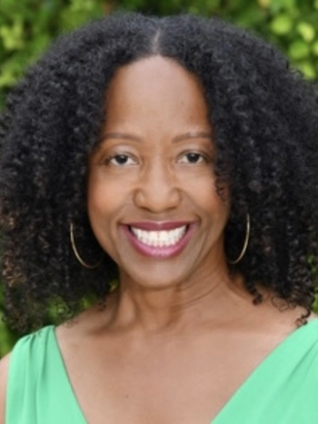photo of Commissioner Diane Robertson with green top and curly black hair