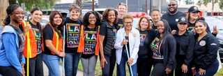 LA Mayor Karen Bass and LA Civil Rights staff, joined by members of the Tom LaBonge family, smiling and holding brooms at the fourth annual Tom LaBonge Day of Service, part of the Mayor's Shine LA neighborhood beautification initiative.